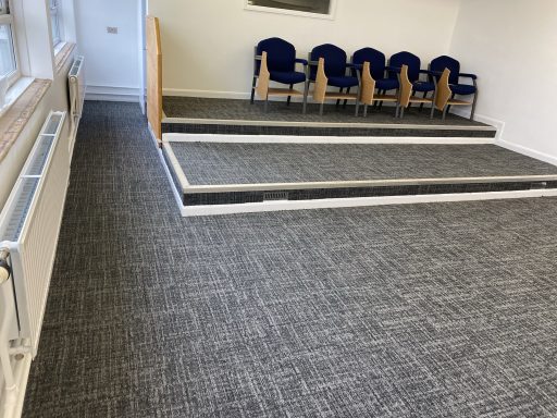 Commercial Carpet Tile to Stage Commercial carpet tile installation with feature steps and access platform.