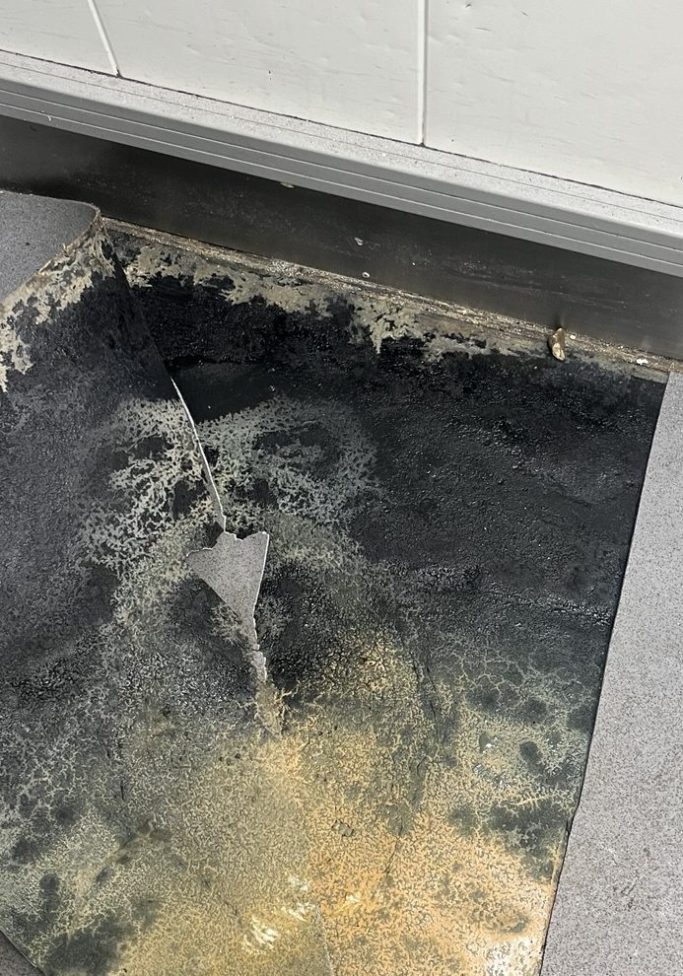 Safety Flooring Repair Before Replacement Failed commercial safety flooring and hygiene-critical floor damage identified during inspection.