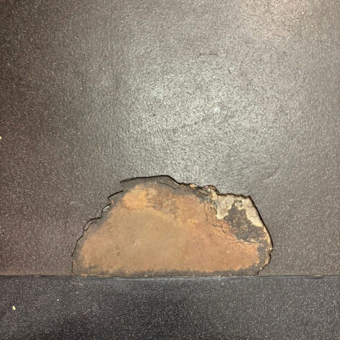 Torn Vinyl Section in Kitchen Failed commercial safety flooring damage identified during inspection.